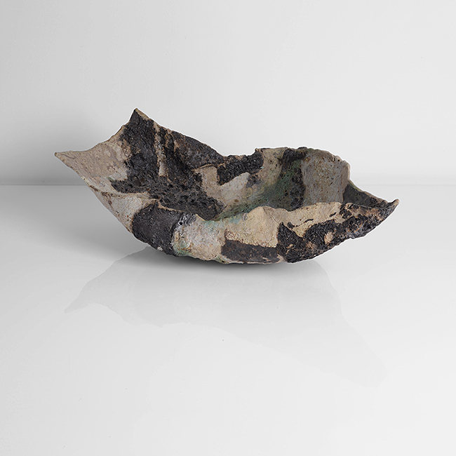 A brown, green and grey mixed laminated clays dish form made by Ewen Henderson in circa 1988 sold at auction by Maak Contemporary Ceramics