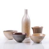 A group of five porcelain vessels in graduated shades of purple brown made by Gwynn Hanssen Pigott in circa 1997 sold at auction by Maak Contemporary Ceramics