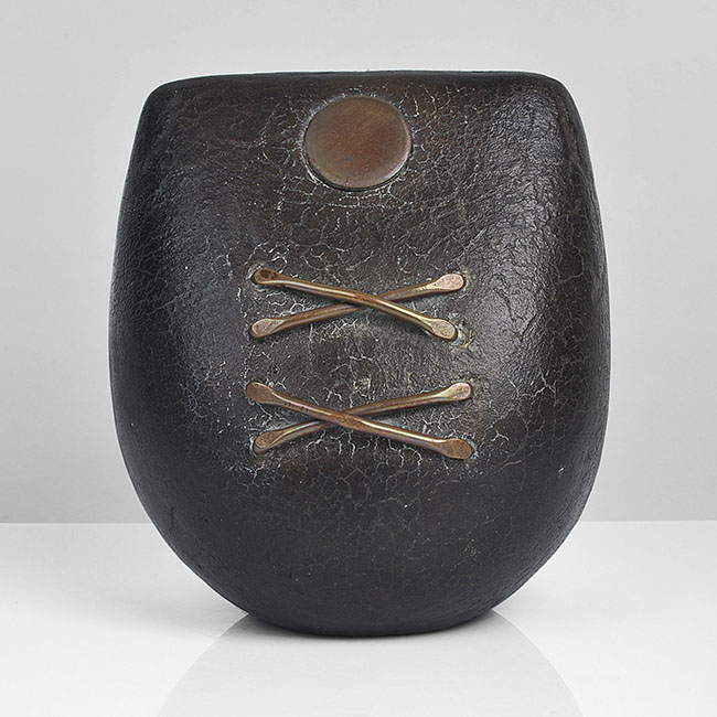 A dark brown raku fired Small Bow Form with Copper made by Peter Hayes in circa 1989 sold at auction by Maak Contemporary Ceramics