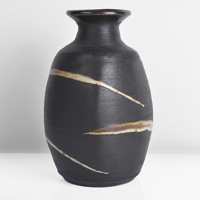 A black stoneware squared bottle made by Janet Leach in circa 1990 sold at auction by Maak Contemporary Ceramics