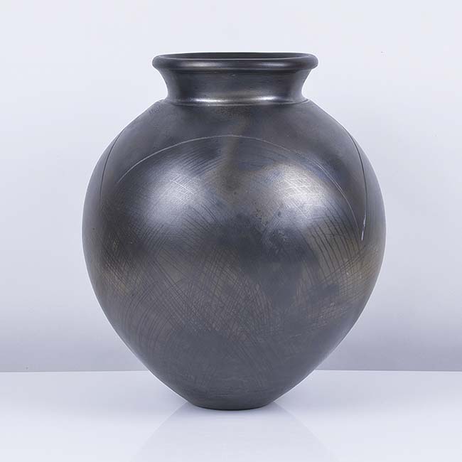 A black earthenware vessel made by Magdalene Odundo in circa 1980 sold at auction by Maak Contemporary Ceramics