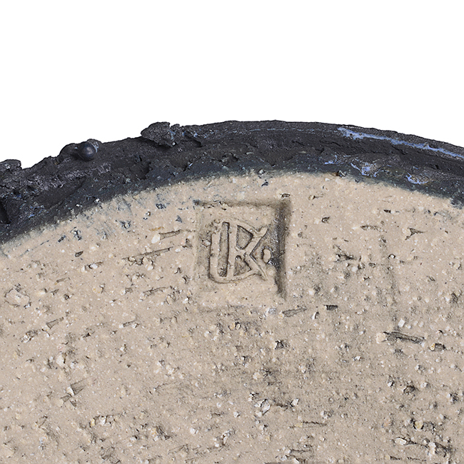 An impressed maker's mark on a black stoneware vessel made by Dan Kelly sold at auction by Maak Contemporary Ceramics