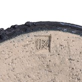 An impressed maker's mark on a black stoneware vessel made by Dan Kelly sold at auction by Maak Contemporary Ceramics