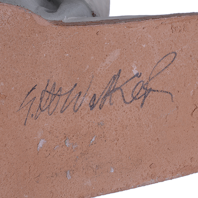 A painted signature on an earthenware sculpture made by Geoffrey Walker