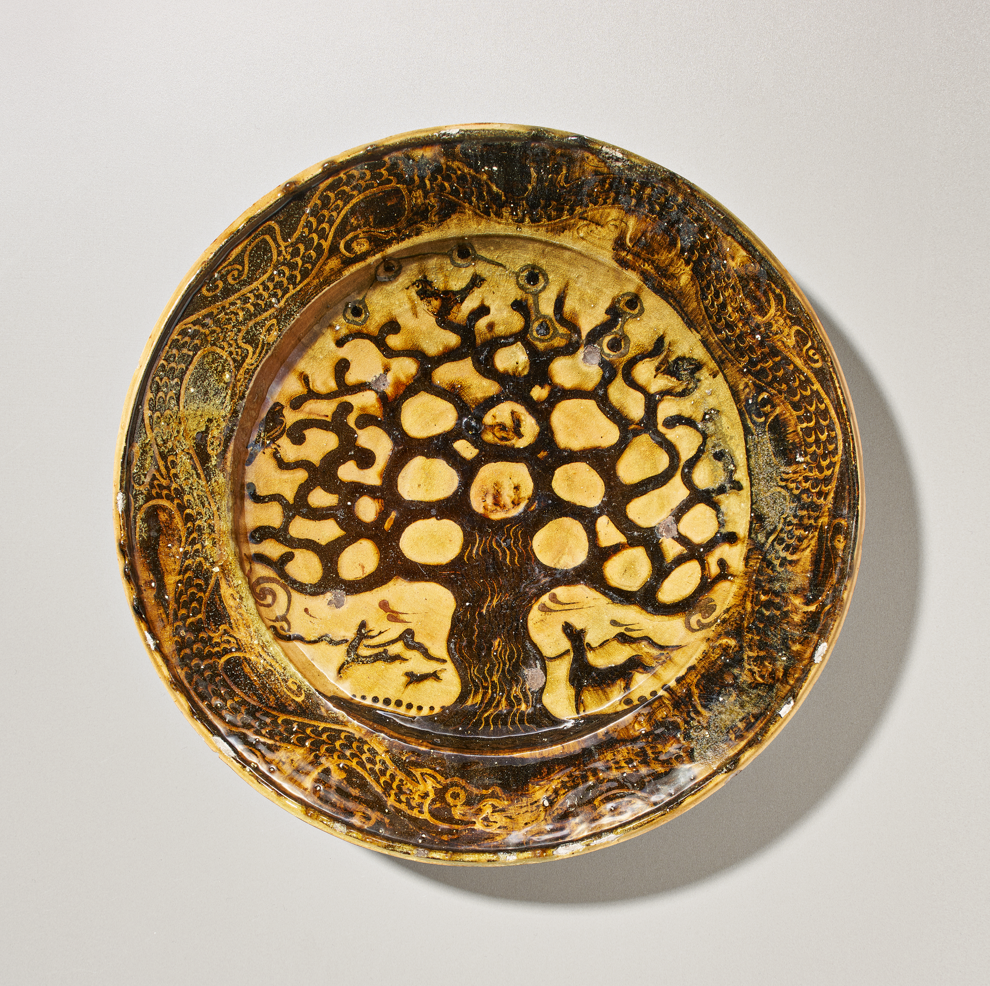 An earthenware charger with 'Tree of Life' design made by Bernard Leach in circa 1924 sold at auction by Phillips in association with Maak