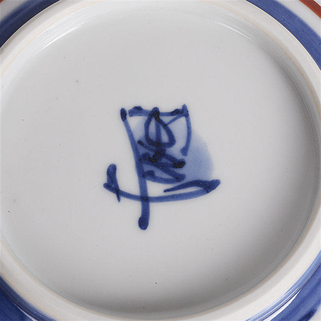A painted maker's mark by Tomimoto Kenkichi on a porcelain dish