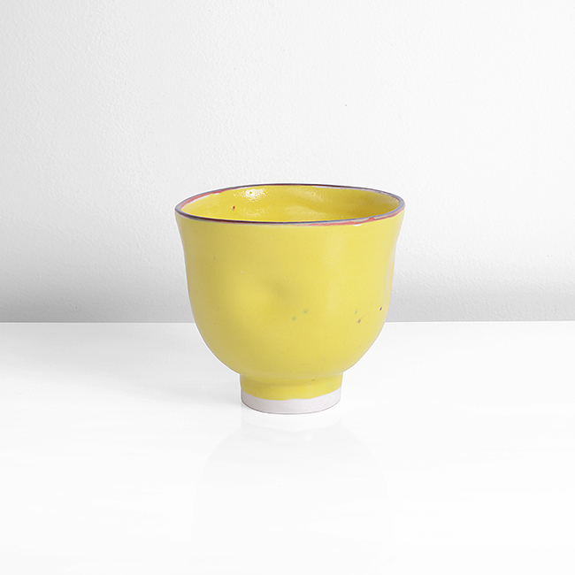 A yellow porcelain tea bowl made by Emmanuel Cooper in 2011 sold at auction by Maak Contemporary Ceramics