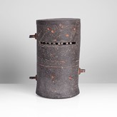 A dark brown raku fired 'Helmet' sculpture made by Mo Jupp in 1995 sold at auction by Maak Contemporary Ceramics