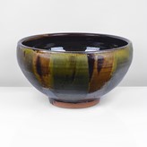 An amber and green earthenware bowl made by Clive Bowen sold at auction by Maak Contemporary Ceramics